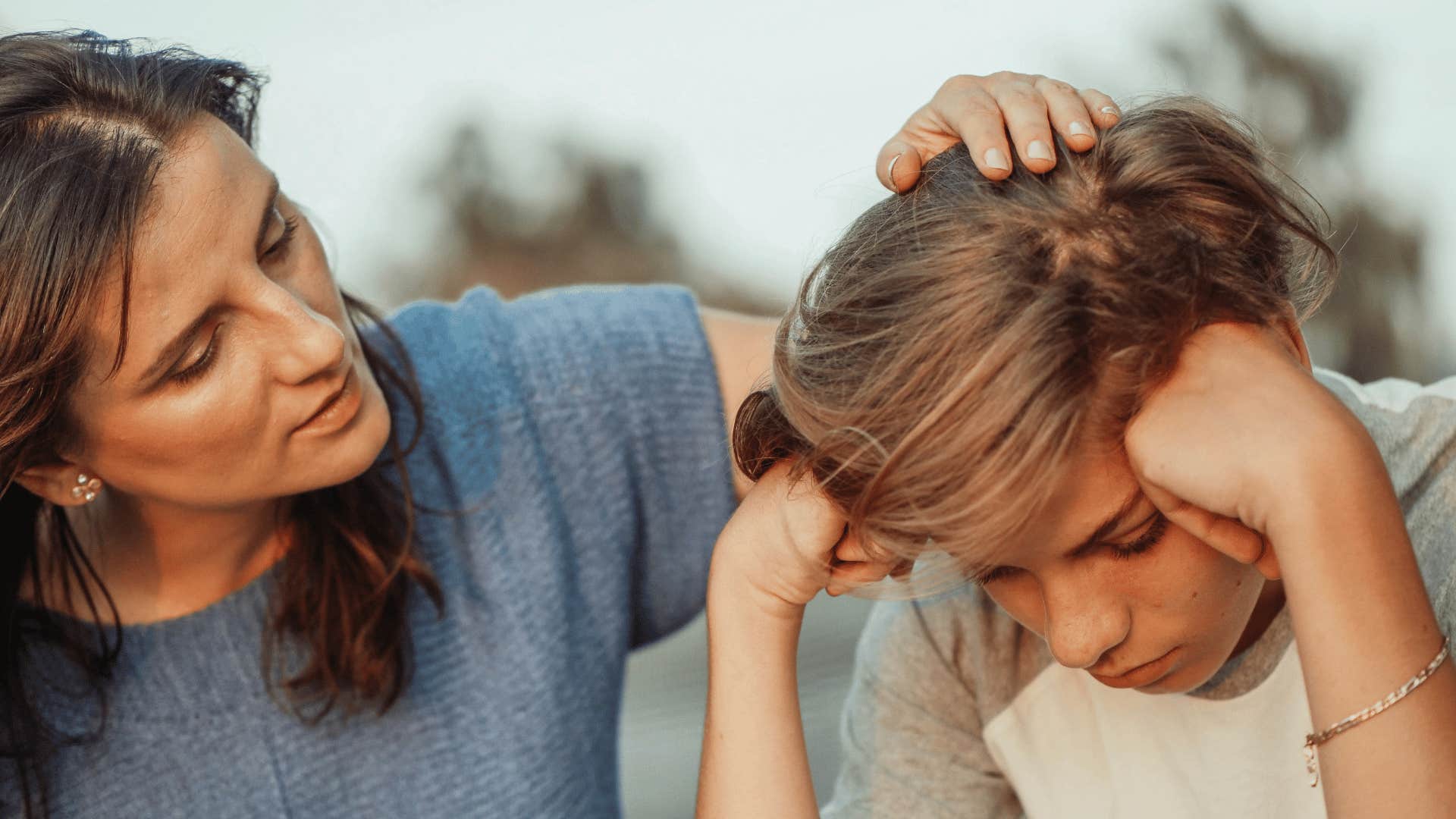 woman talking to upset child