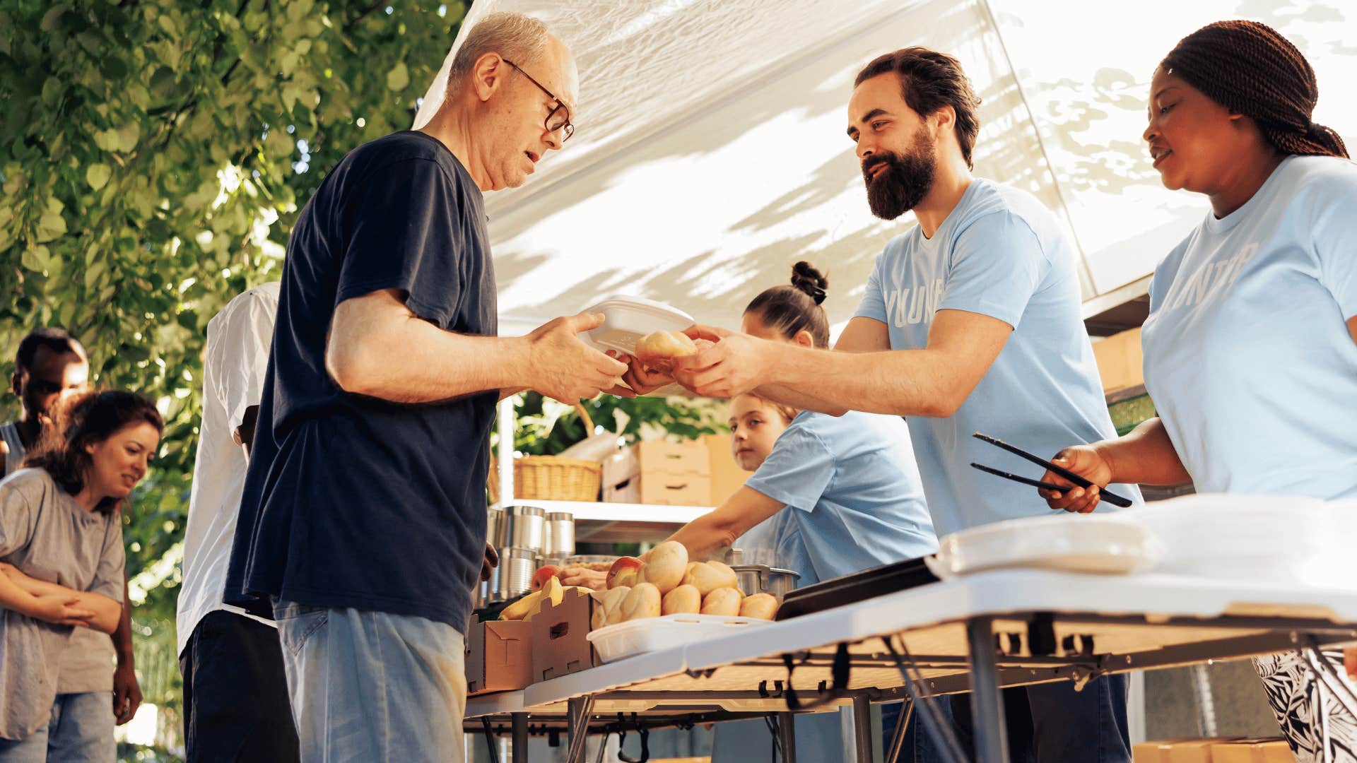 man giving food to person 