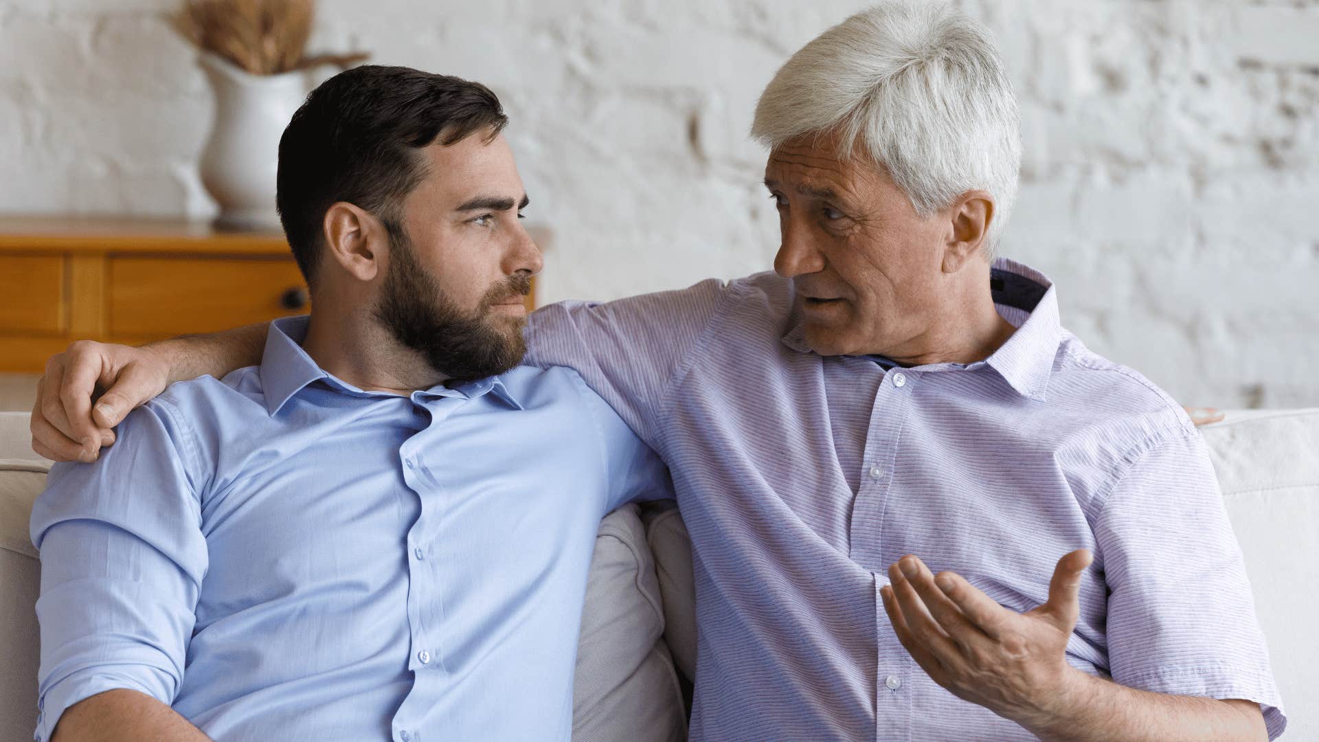 older man explaining something to younger man