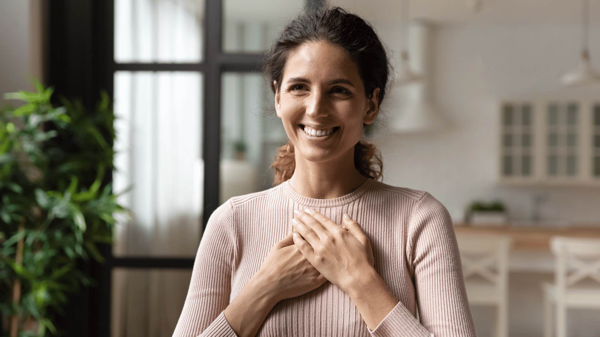 woman with hand over heart 