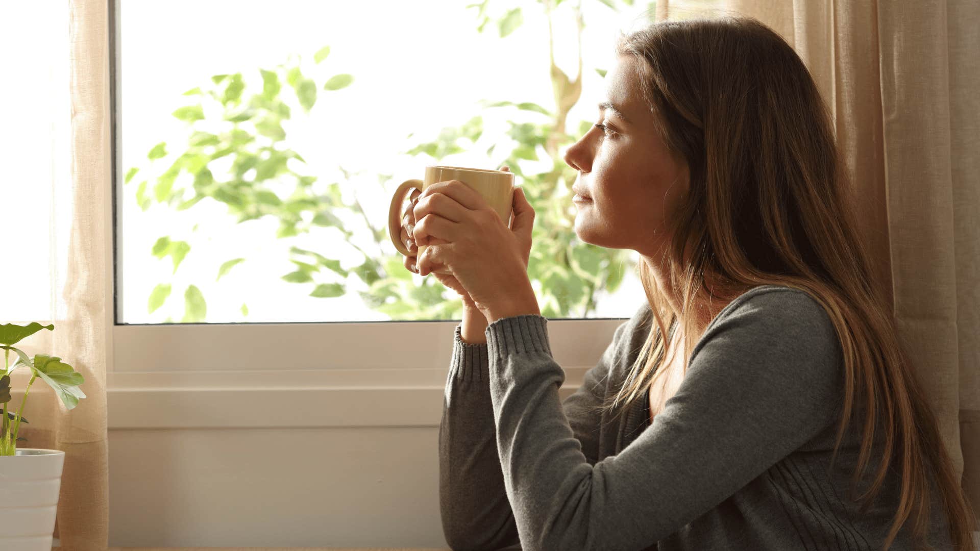 woman looking out the window