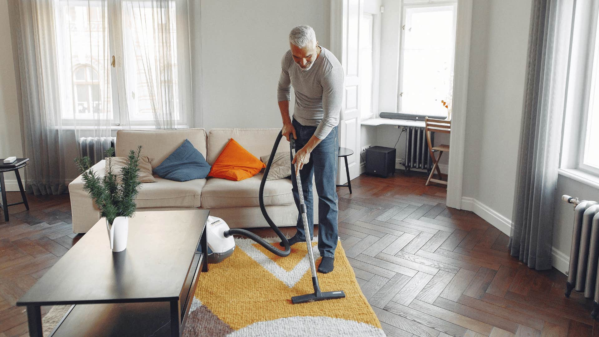 man vacuuming the living room