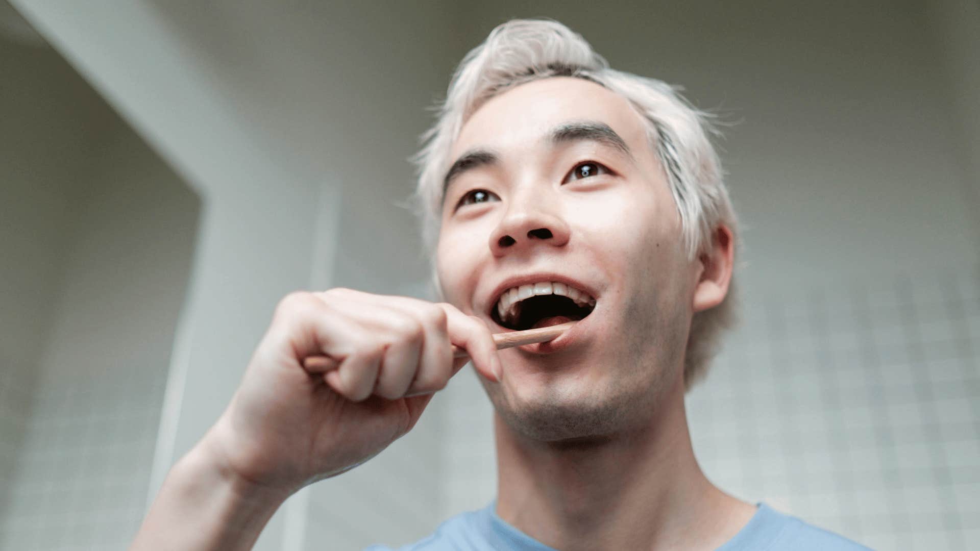 man brushing his teeth