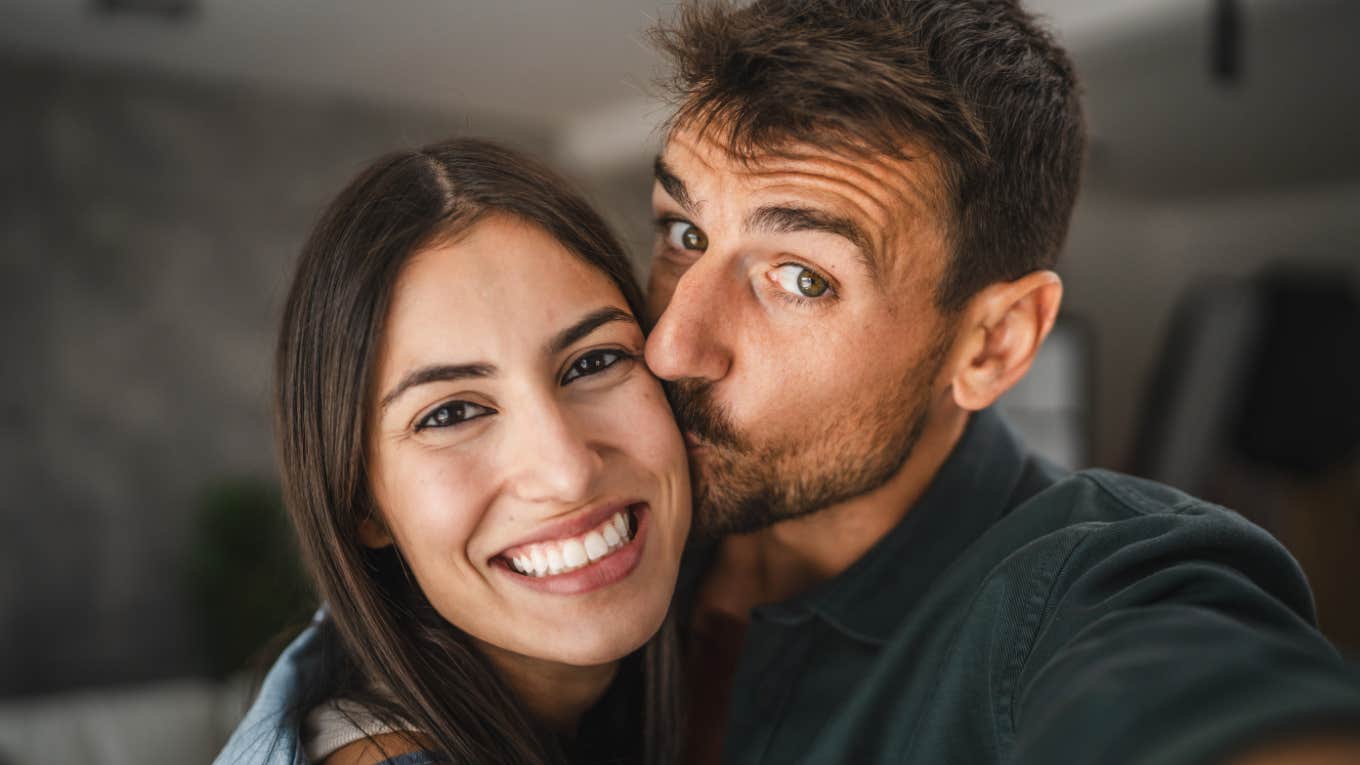 man kissing woman's cheek lovingly