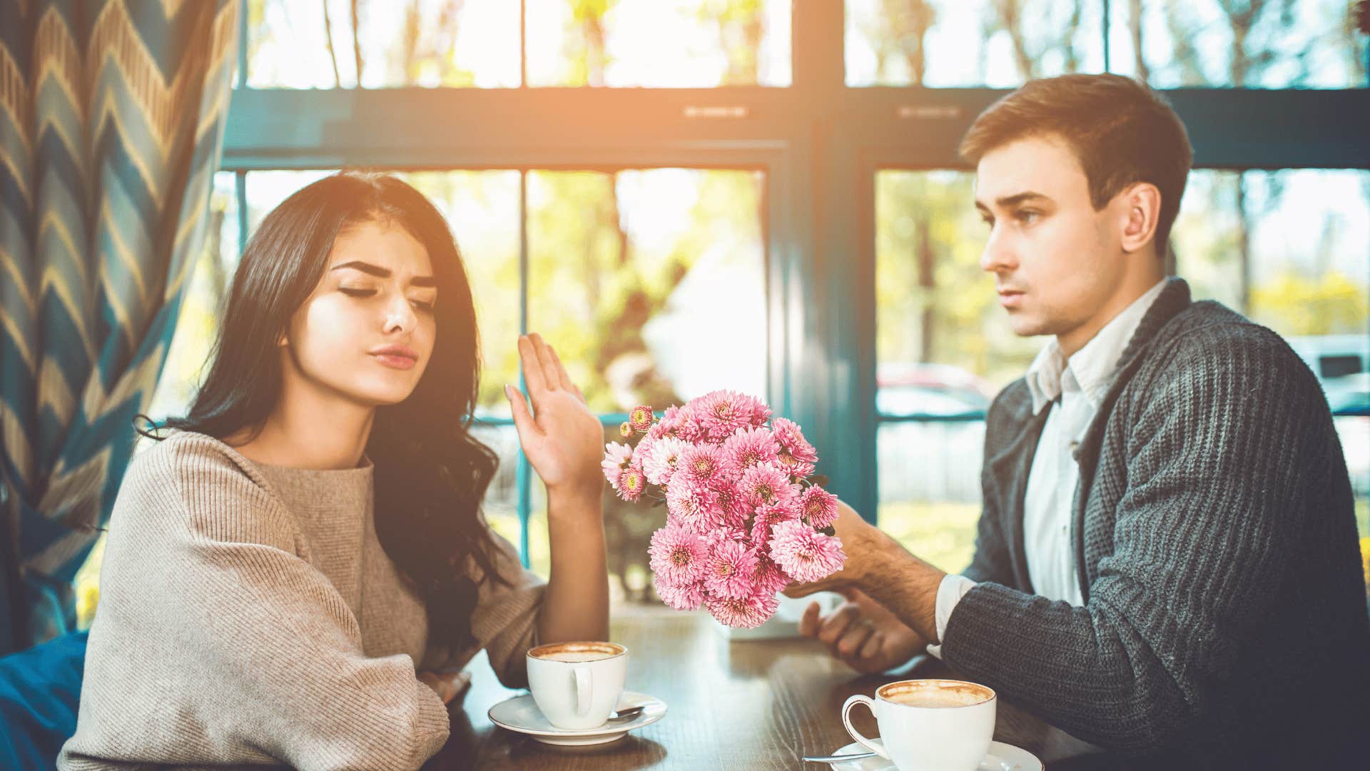 He offers flowers, she offers a hand that says, Nope