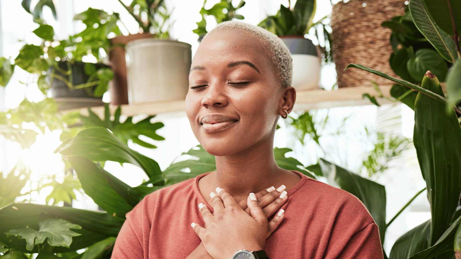 With hands to heart, she closes her eyes and meditates