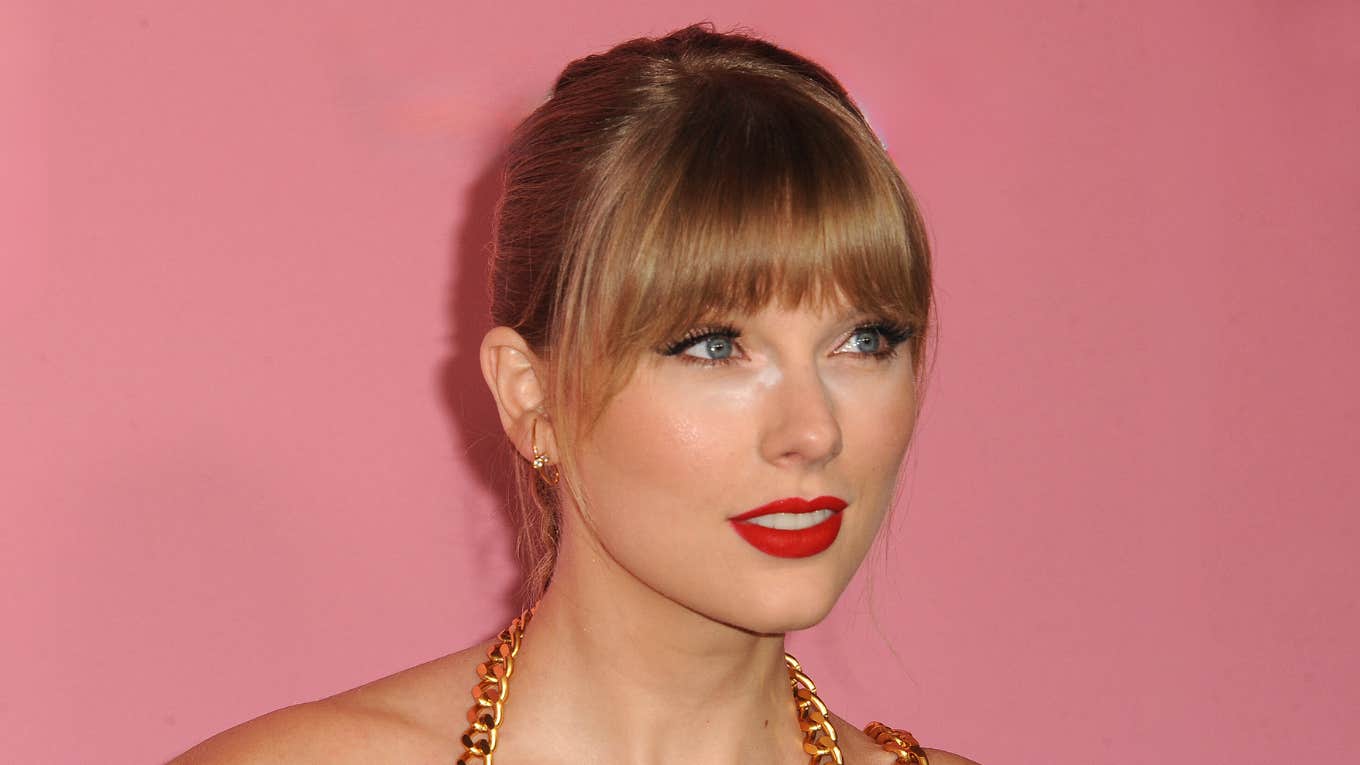 Taylor Swift with hair up and slight smile