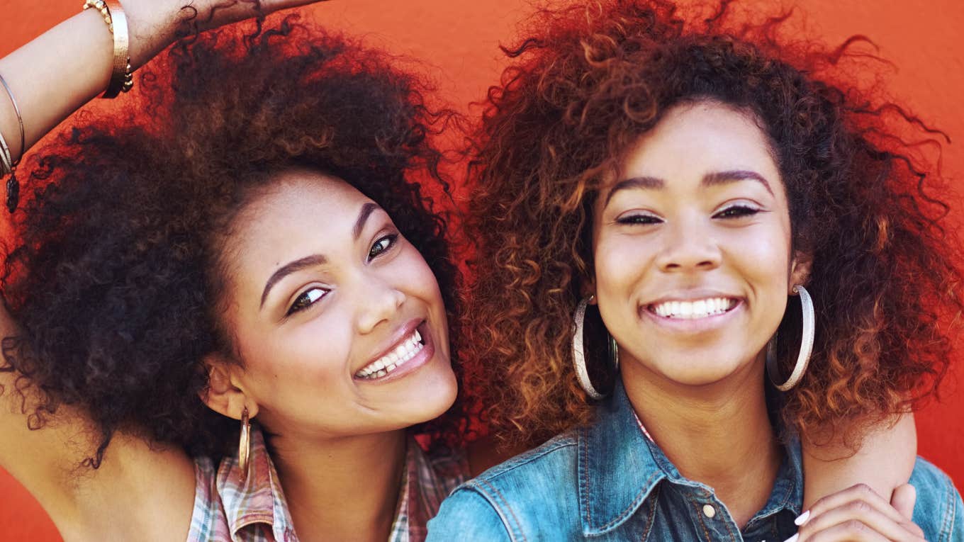 Two young women smiling and enjoying each other's company