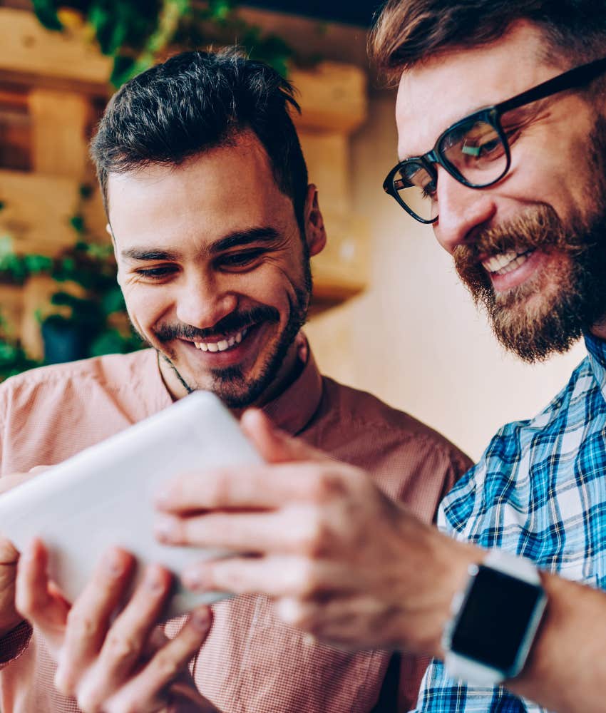 two friends laughing at photo