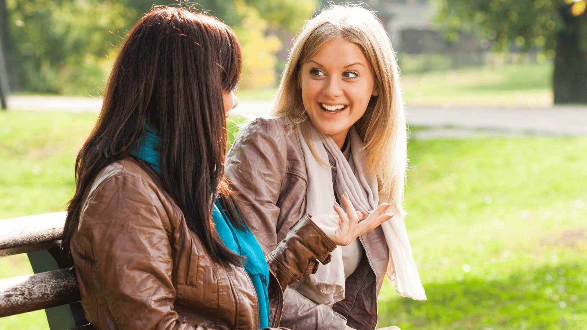 two women gossiping on bench