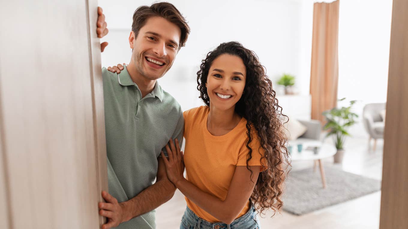 Couple opening the door to uninvited guests