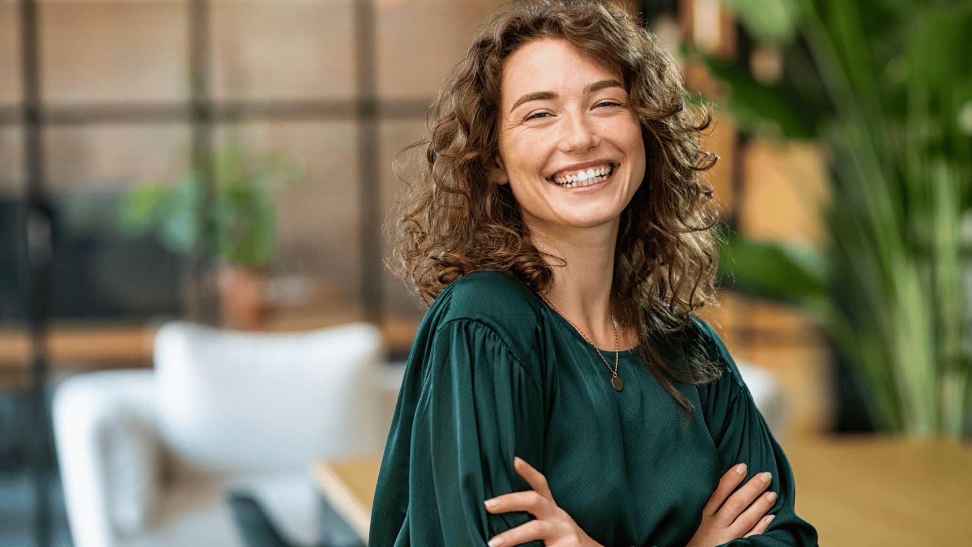 woman smiling while crossing arms 