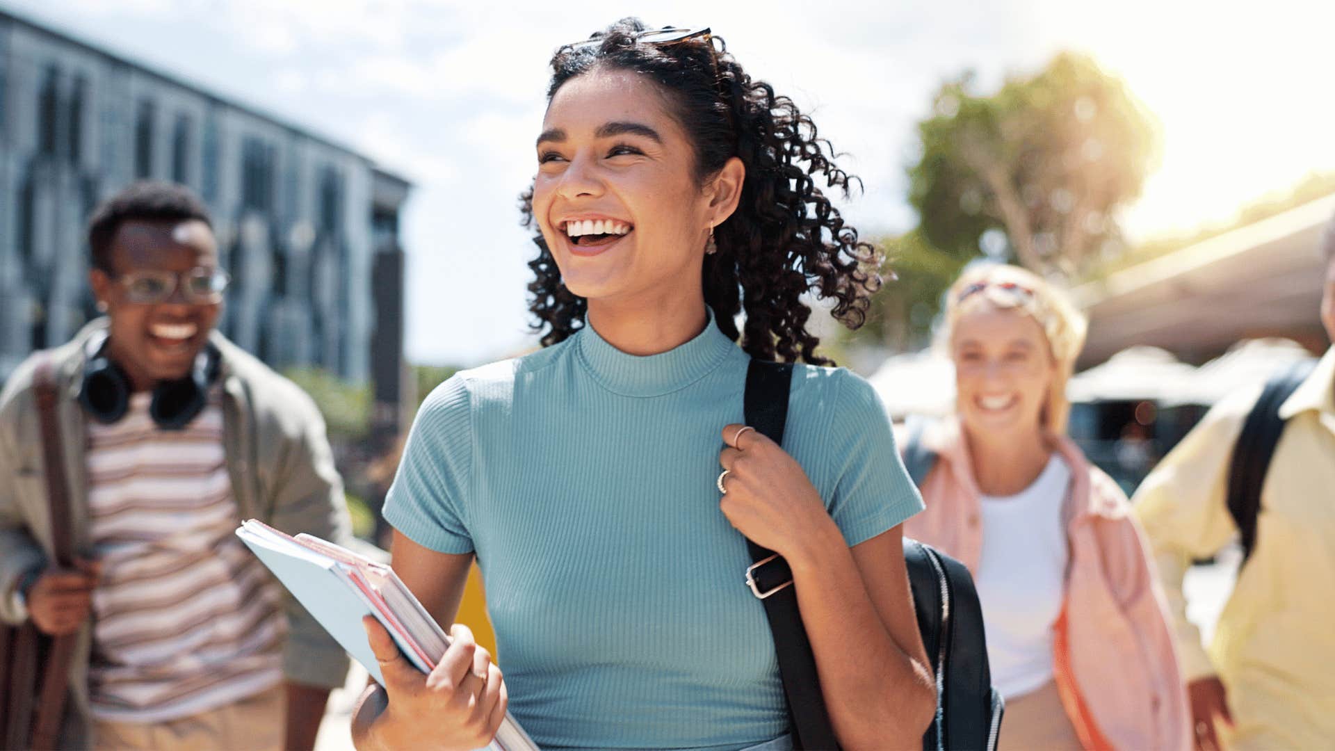 college student smiling while walking