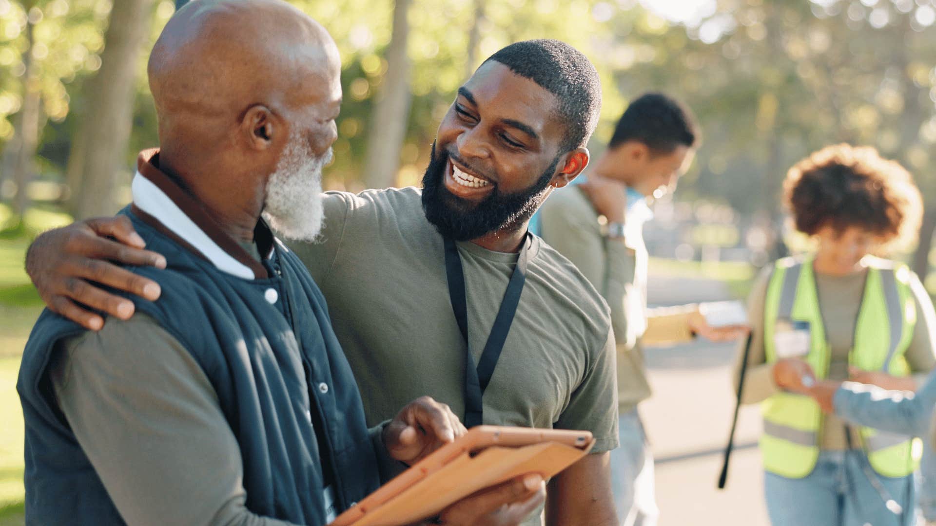 man putting hand on another mans shoulder 