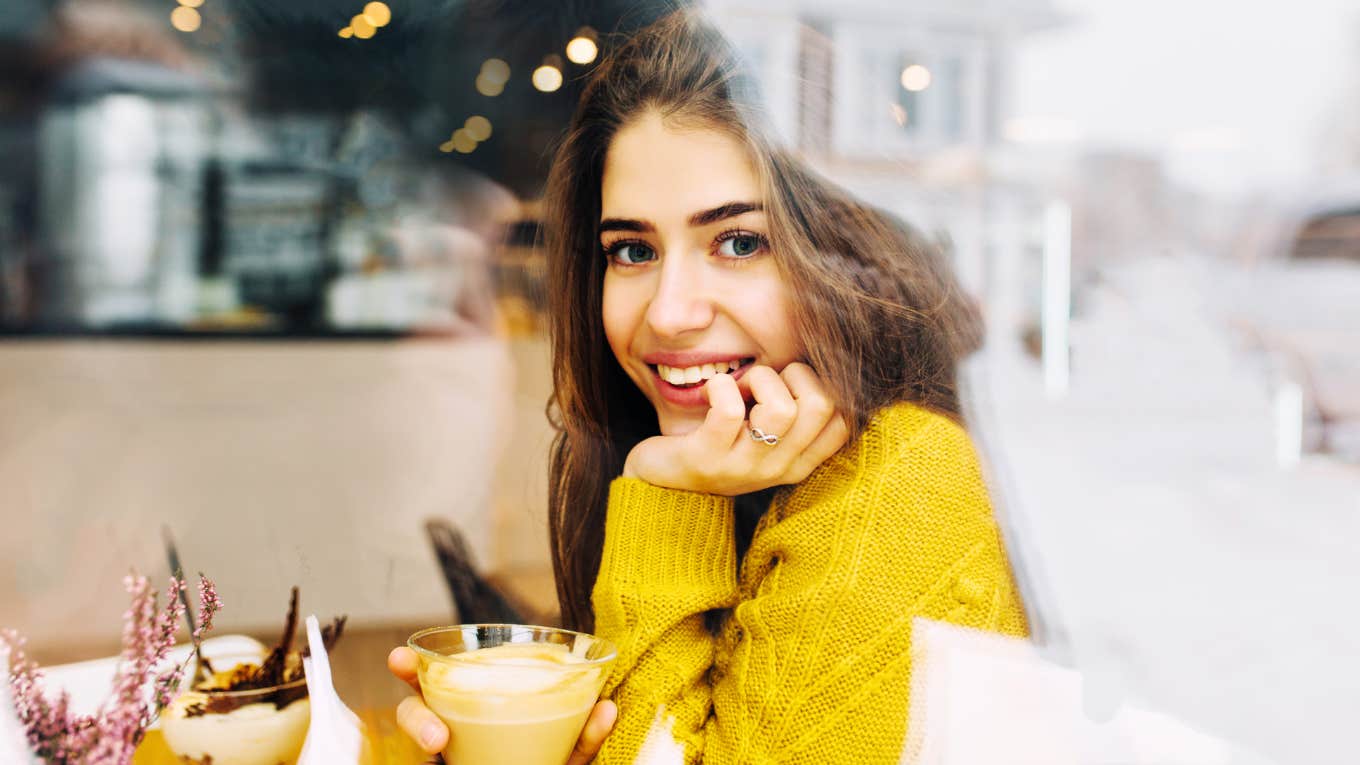 Smiling woman, showing man outside she's interested