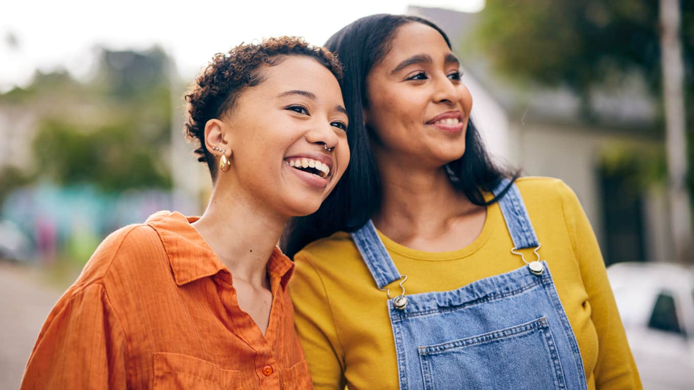 girl friends smiling together outside