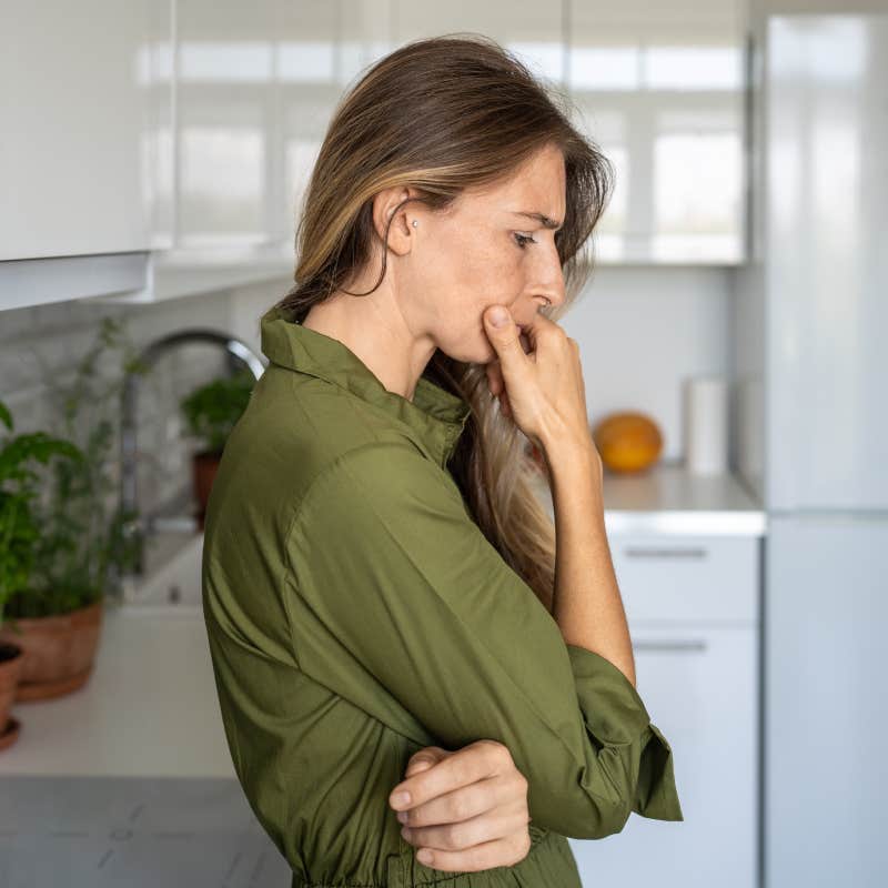 frustrated woman thinking with hand under her chin