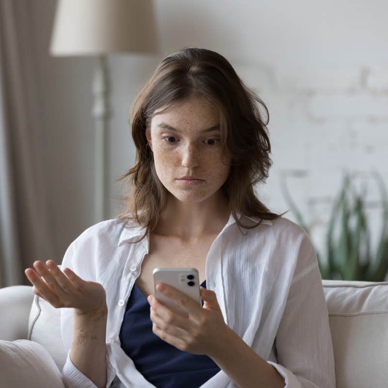 shocked woman looking at phone