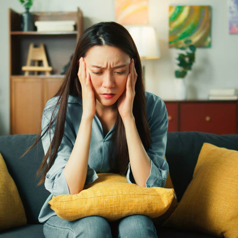 woman exhausted sitting on couch