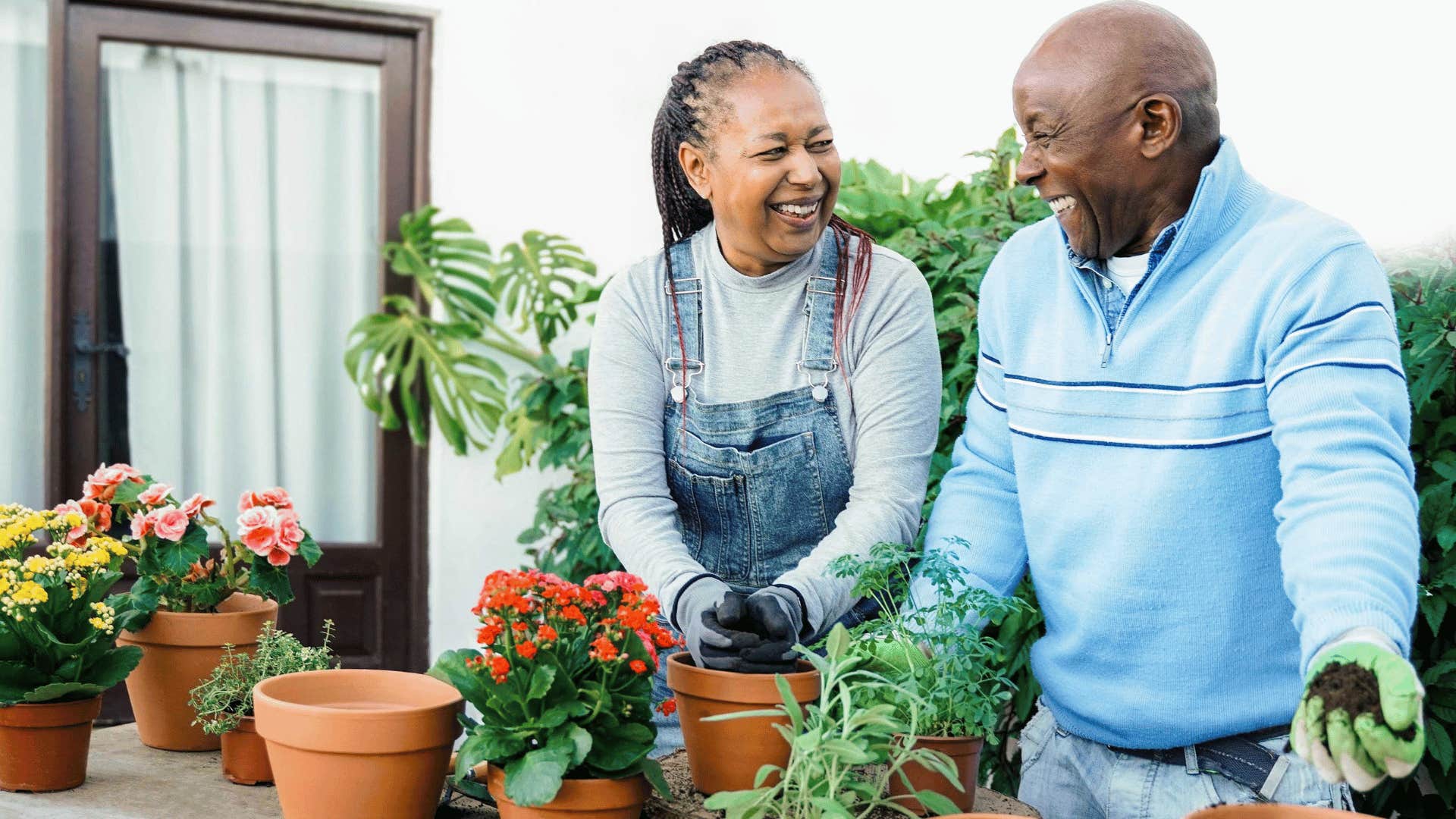 Happy couple repotting plants together