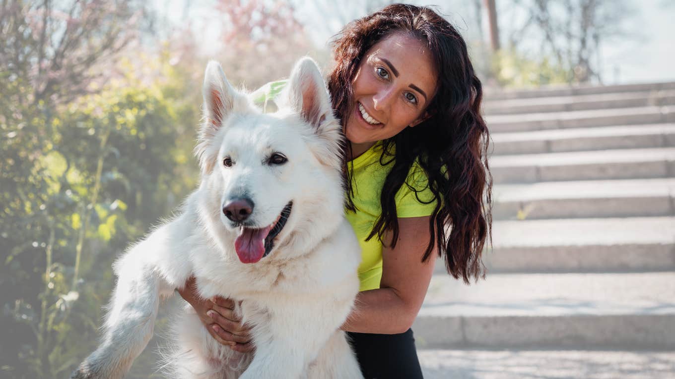 Dog owner smiling while bringing her dog in public. 