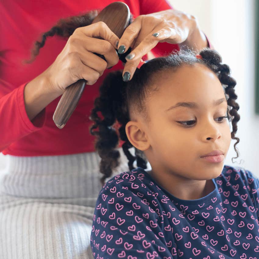 woman braiding young girls