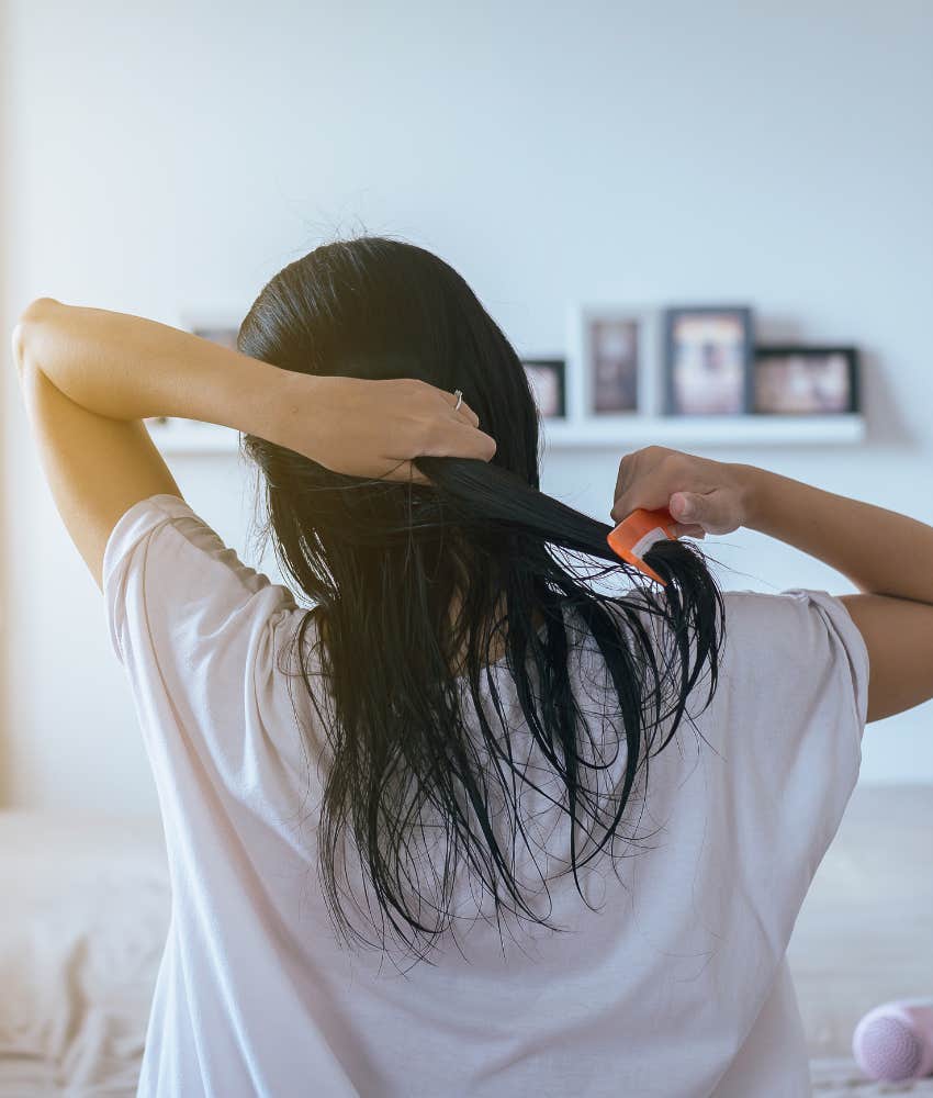 Woman combing wet hair