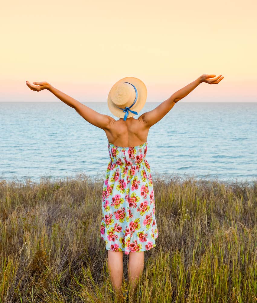 Woman with arms up in nature