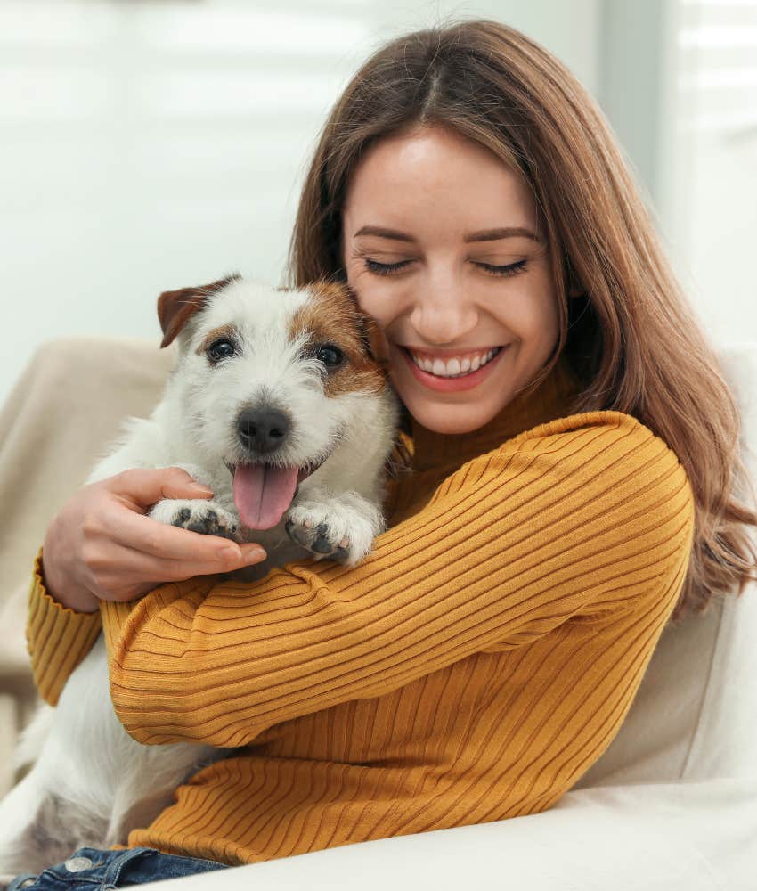 Woman happily hugging her dog