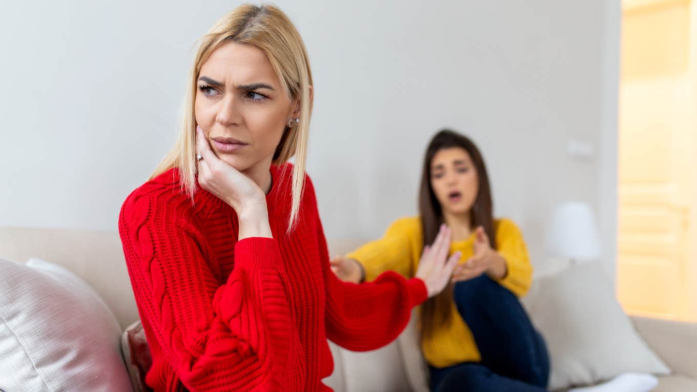 one woman trying to apologize while another angry woman looks away