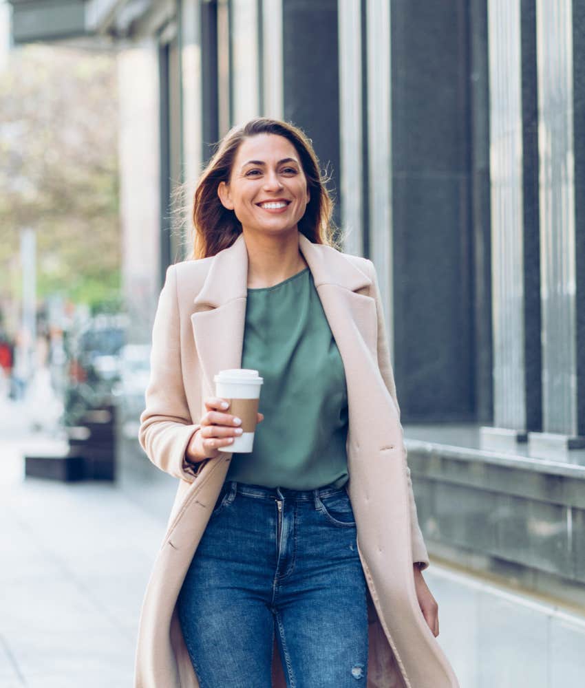 woman walking with a cup of coffee