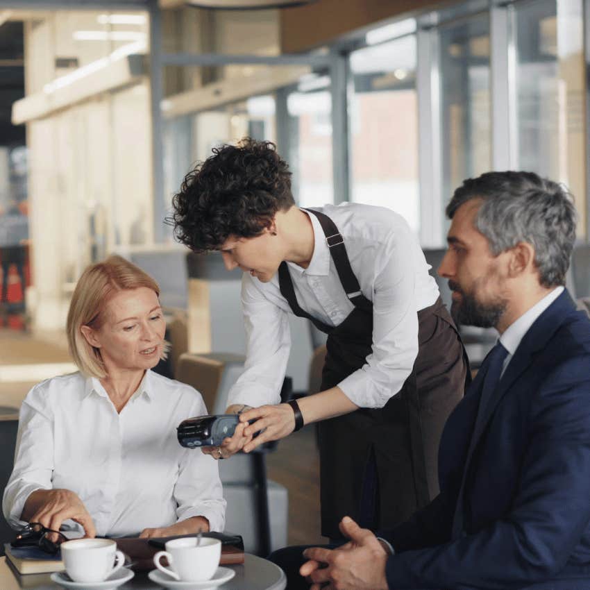 woman paying for coffee date