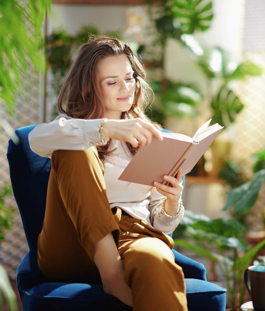 Woman relaxing at home reading a book