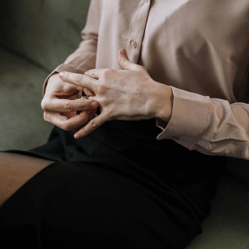 woman removing wedding ring