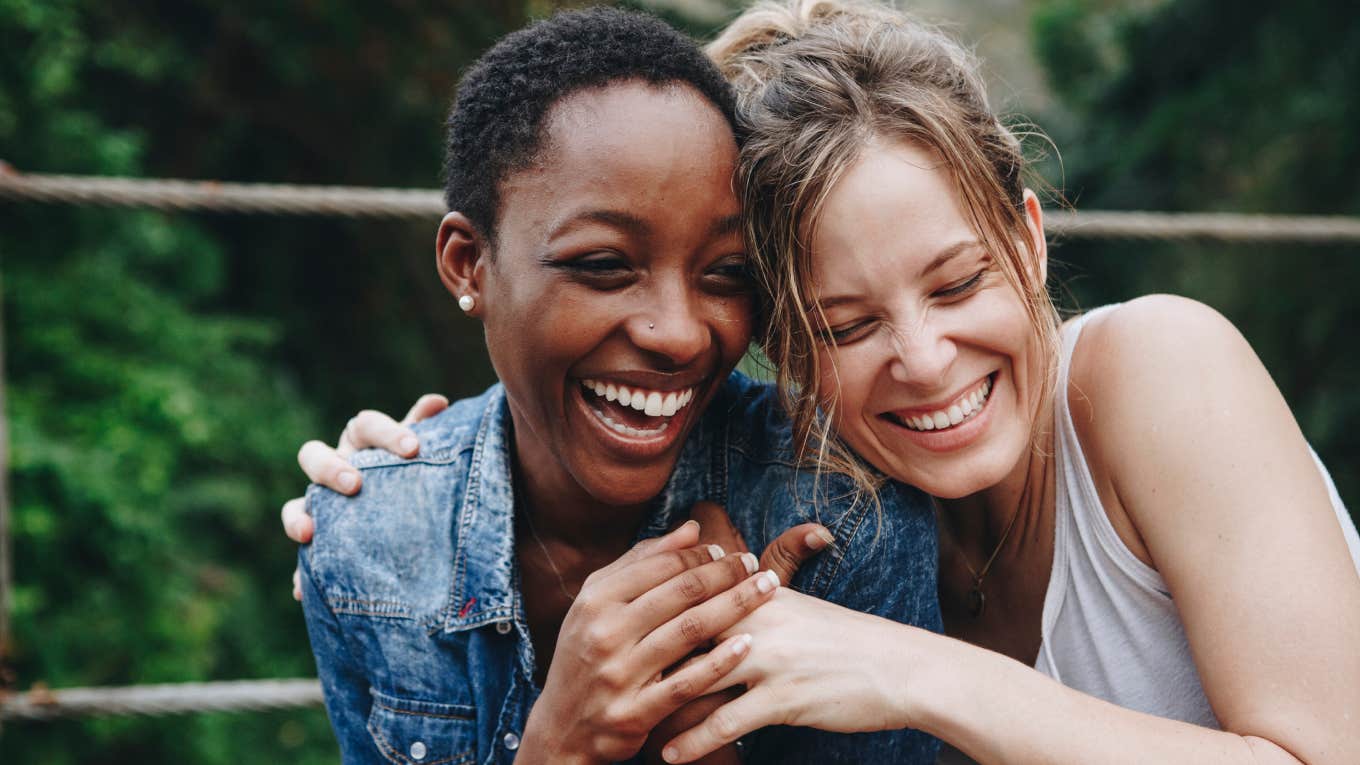 two friends hugging and smiling