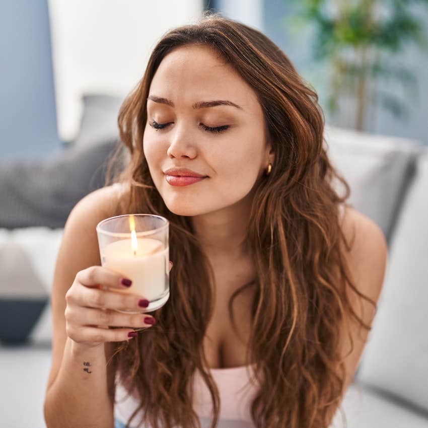 American woman smelling a candle