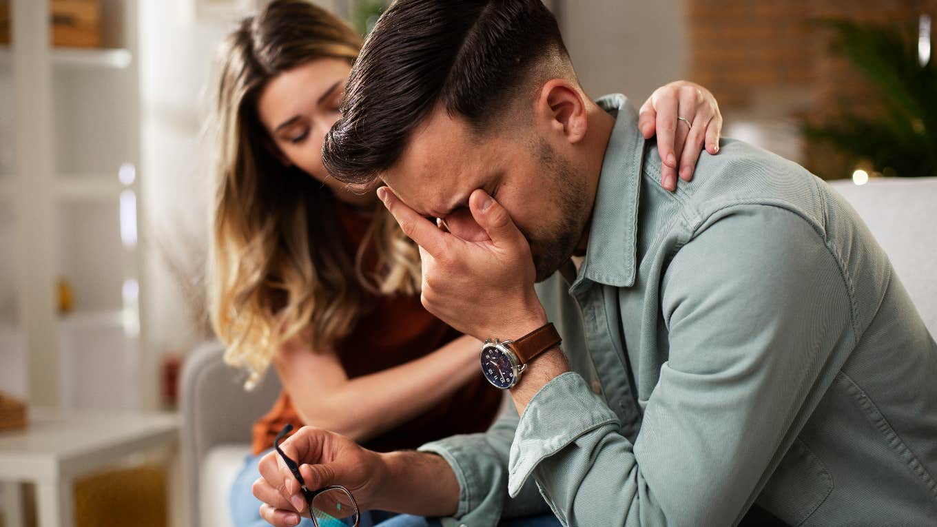 Woman comforting her fiancé while he cries