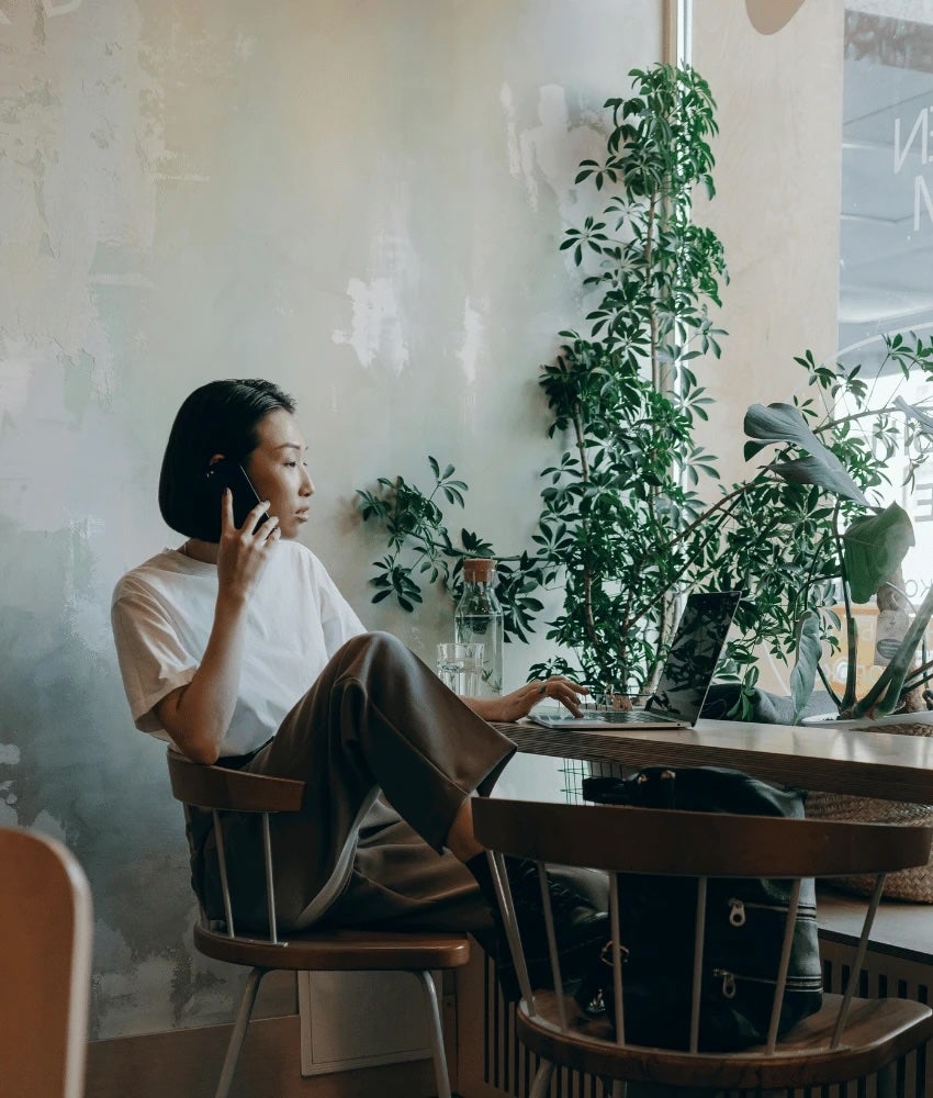 Woman working on her laptop at a coffee shop