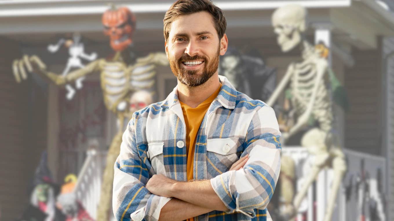 Man standing in front of skeleton Halloween home decorations