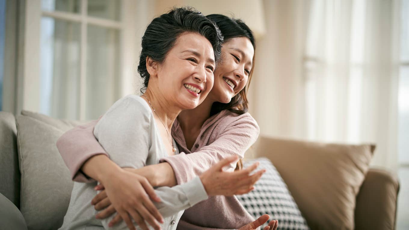 woman hugging mom on couch