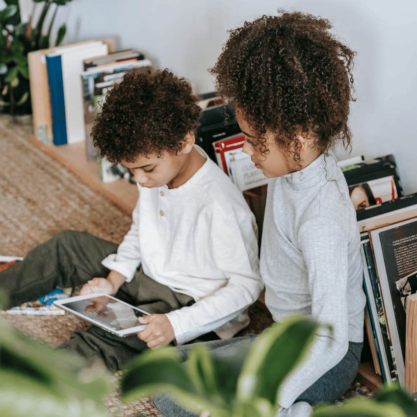 young boy and young girl looking at tablet