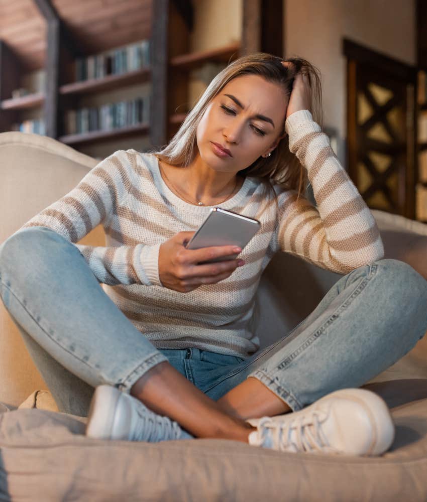 young woman looking at social media with concern