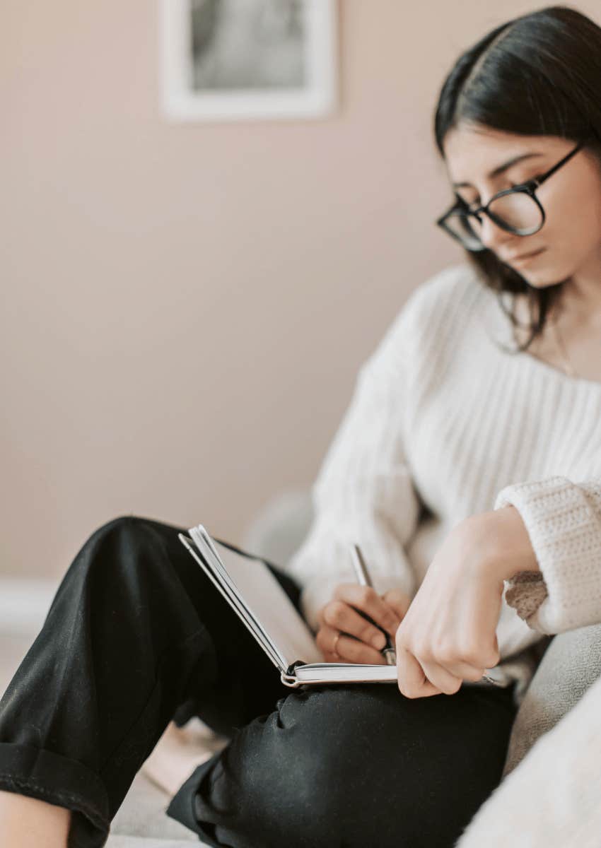 young woman journaling in a notebook