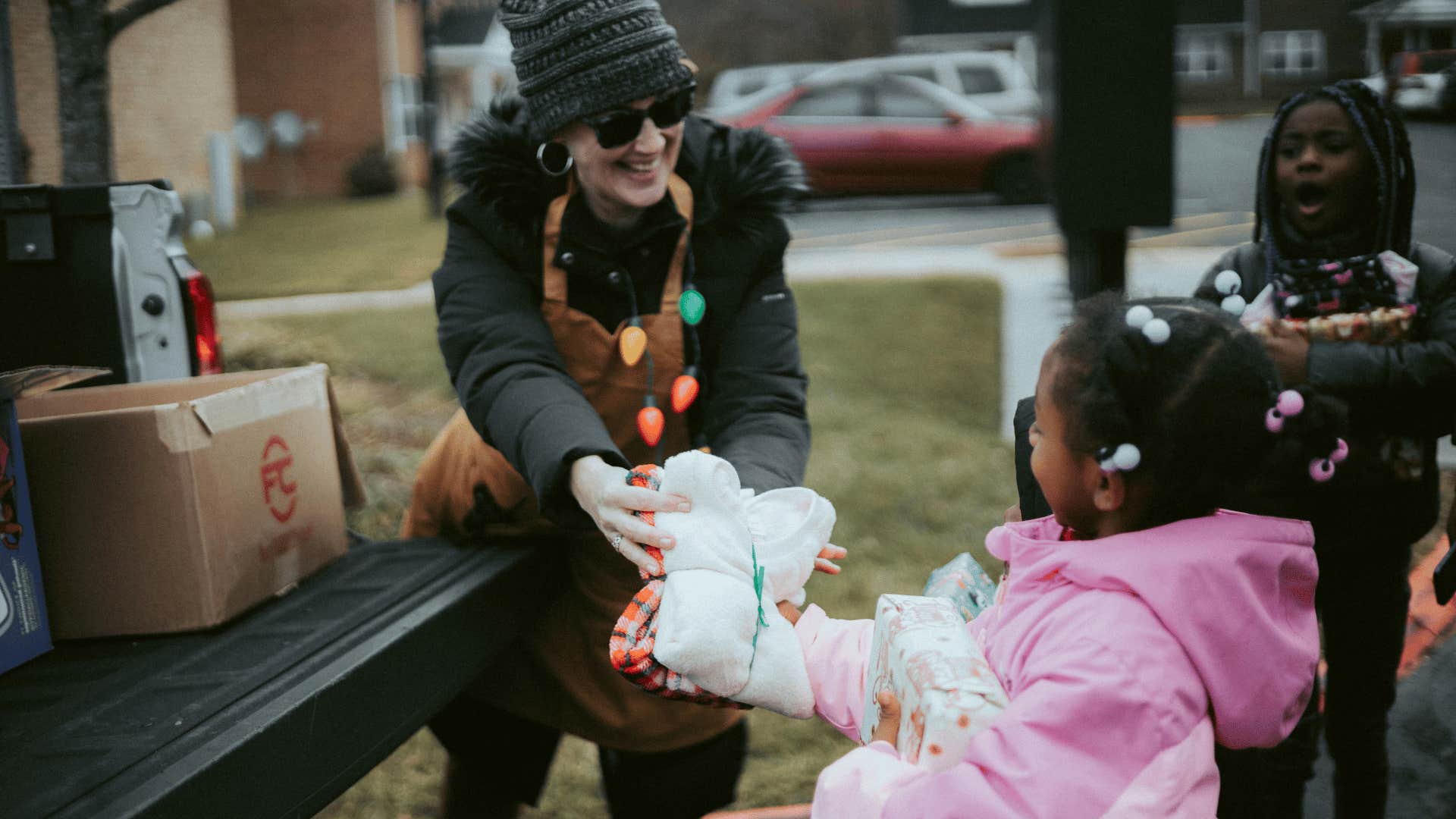 woman giving a young girl a gift