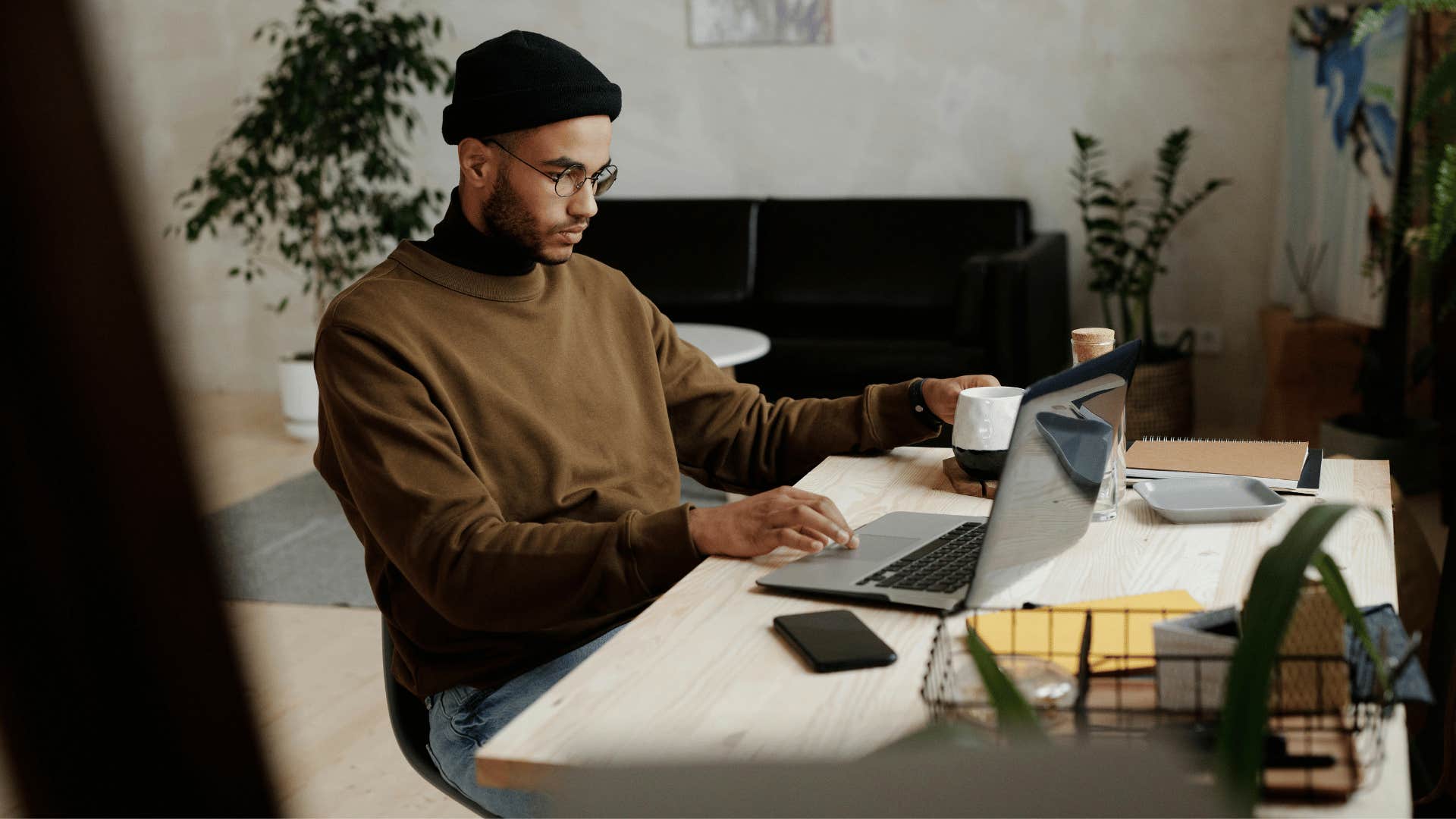 young man focused on an open laptop