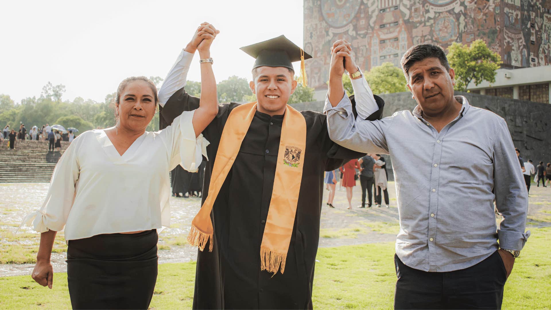 proud parents standing with a graduate