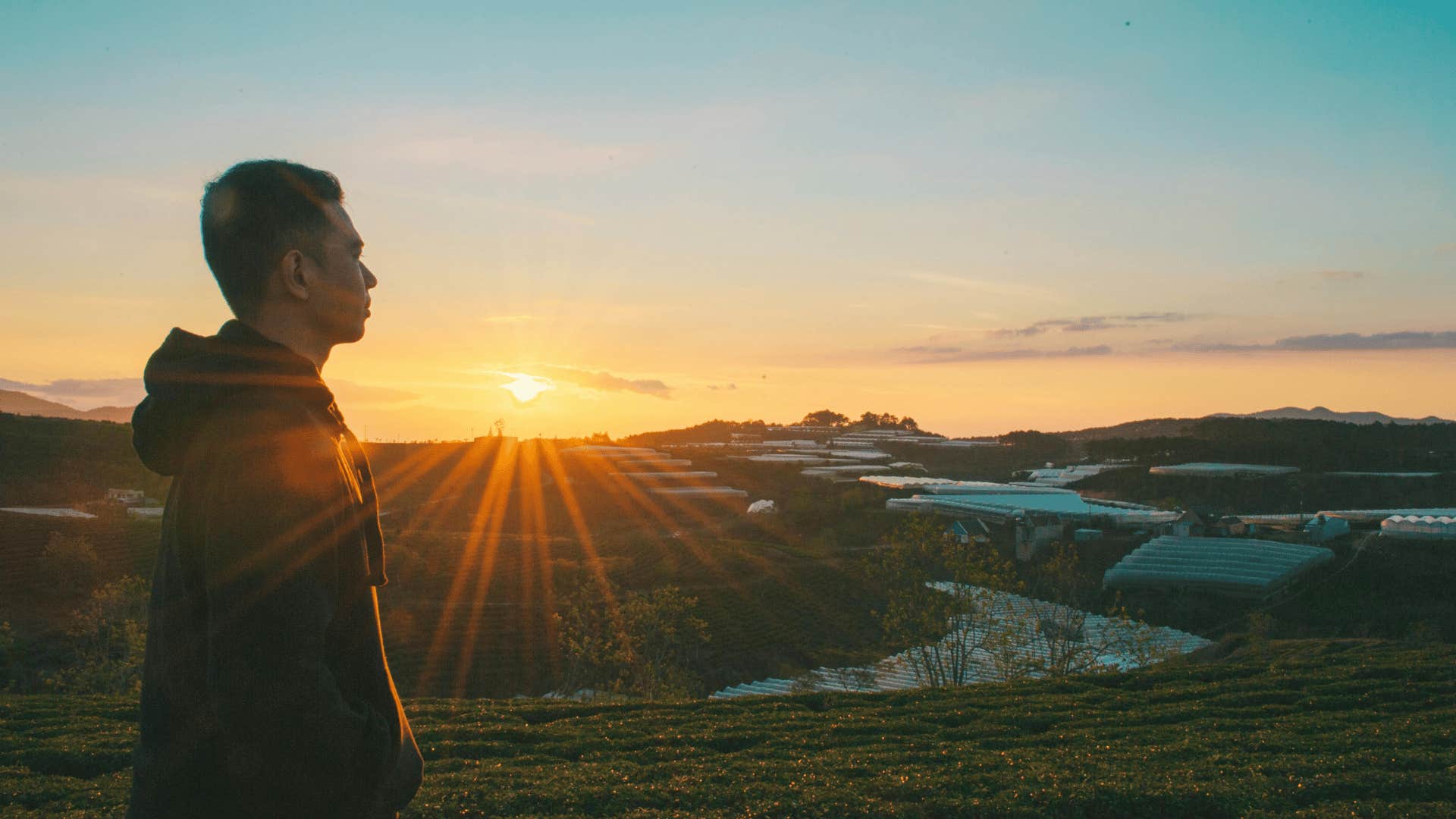 man standing outdoors during sunrise