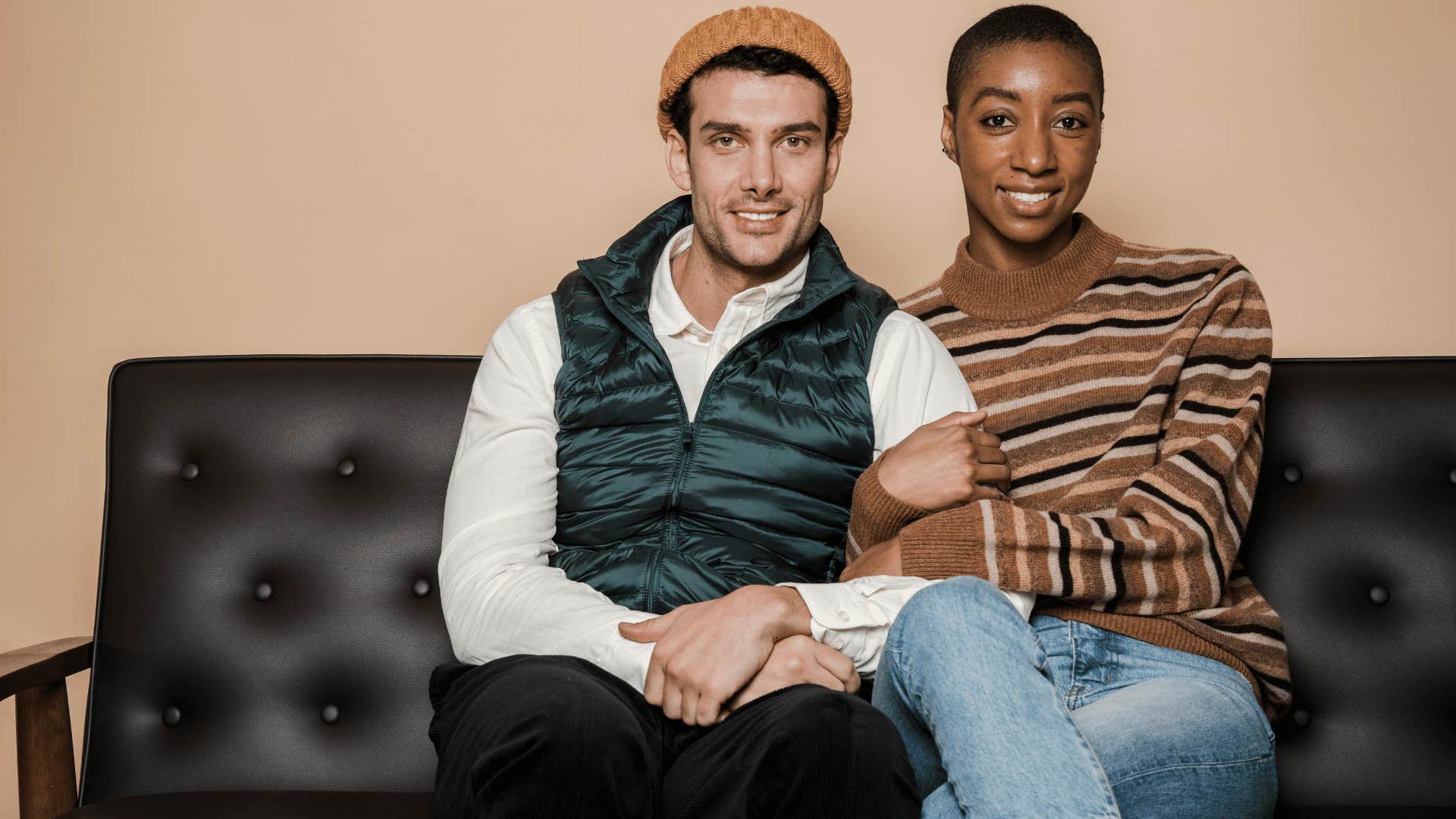 happy couple sitting close together on a couch