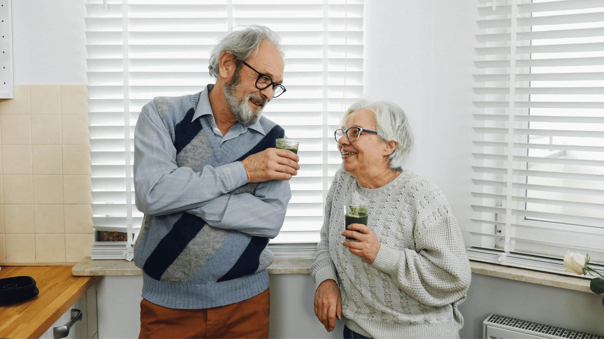 elderly couple drinking green juice