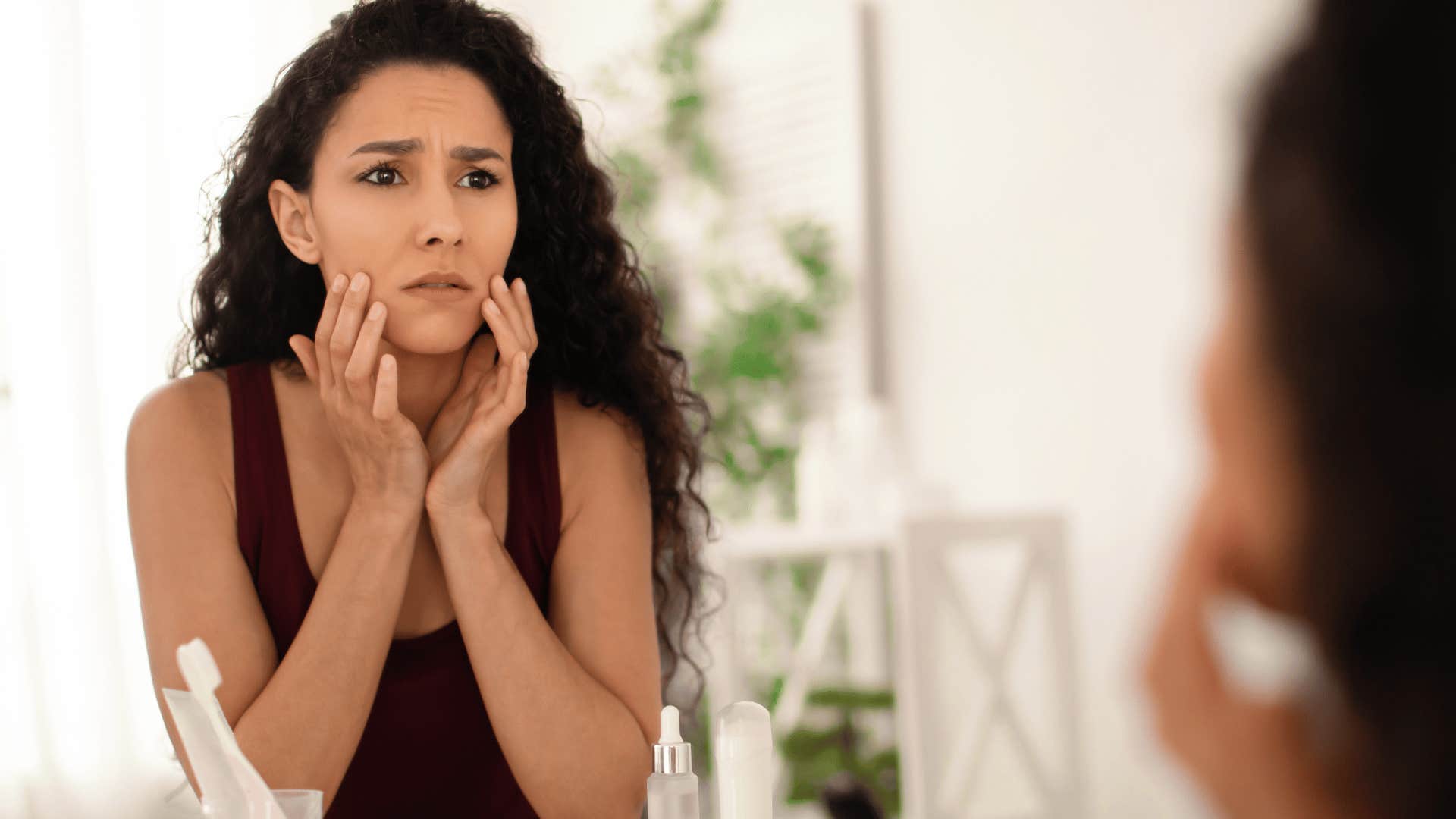 upset woman looking at her own reflection